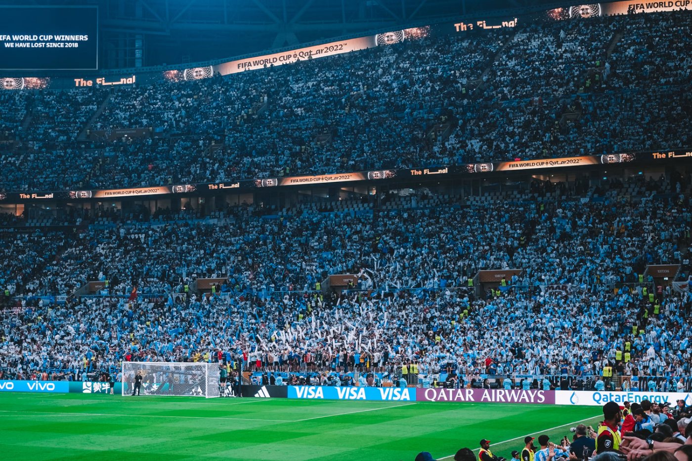 A packed stadium under floodlights on a match night