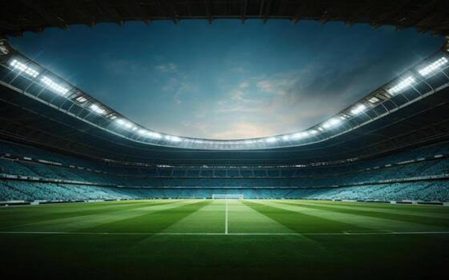 A floodlit soccer stadium at dusk